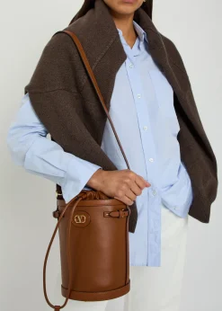 Logo-plaque leather drawstring bucket bag